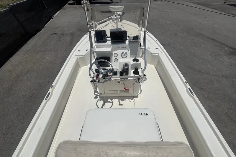 Slide: The Image of 2014 Mako 21 LTS boat interior with steering console and navigation equipment. - 17