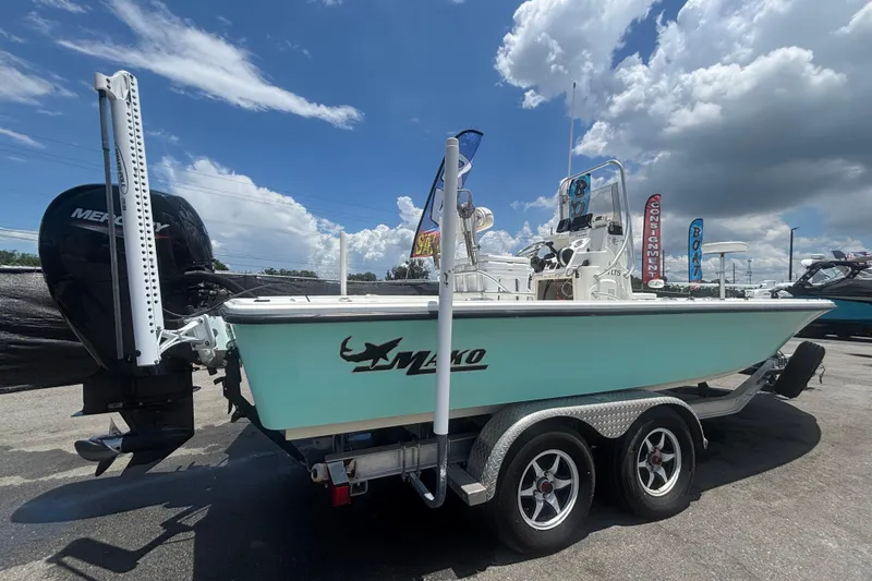 Slide: The Image of 2014 Mako 21 LTS boat on trailer under cloudy sky. - 2