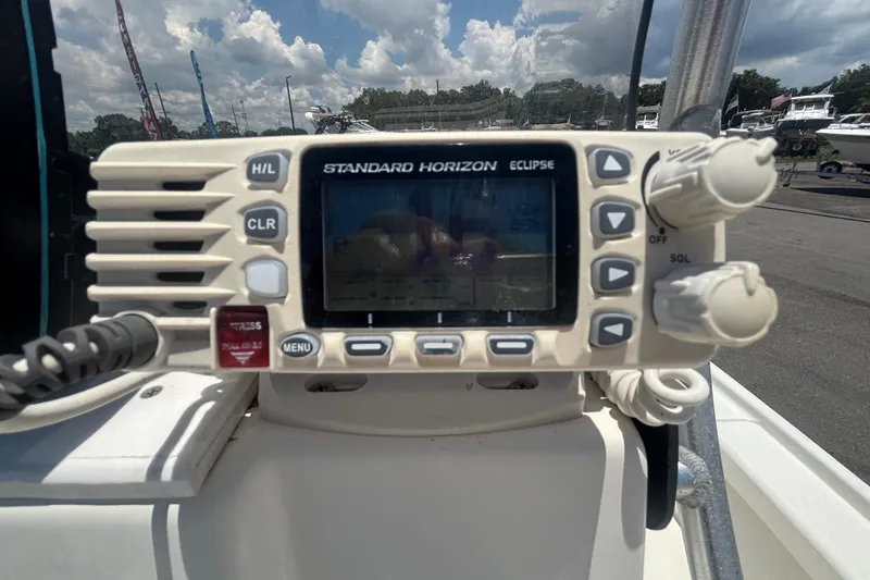 Slide: The Image of Standard Horizon Eclipse radio on 2014 Mako 21 LTS boat dashboard under cloudy sky. - 21