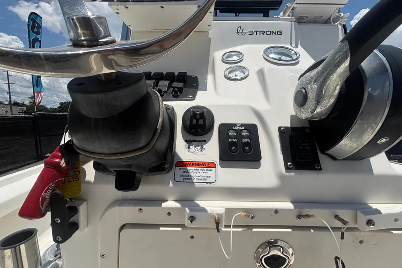 Slide: The Image of Control panel of a 2014 Mako 21 LTS boat with steering wheel and gauges. - 24