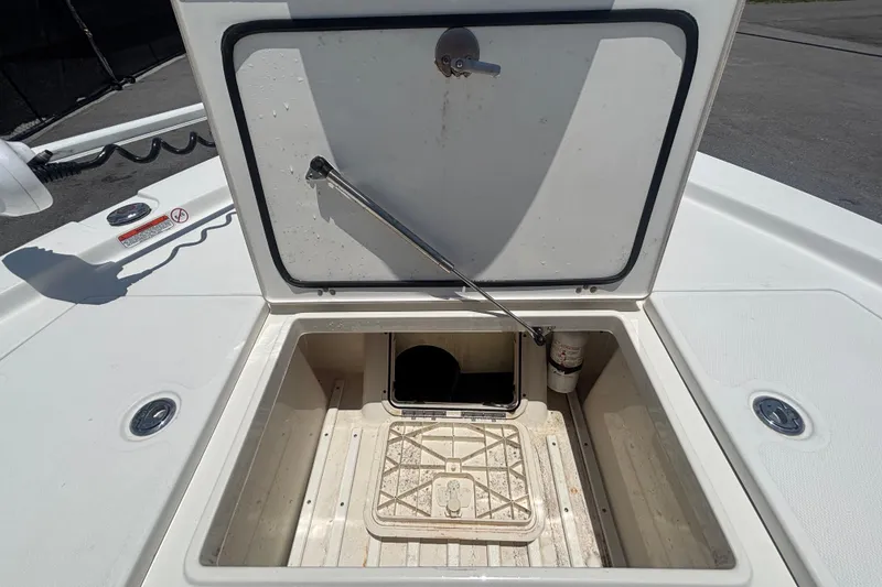 Slide: The Image of Open storage compartment on a 2014 Mako 21 LTS boat deck. - 30