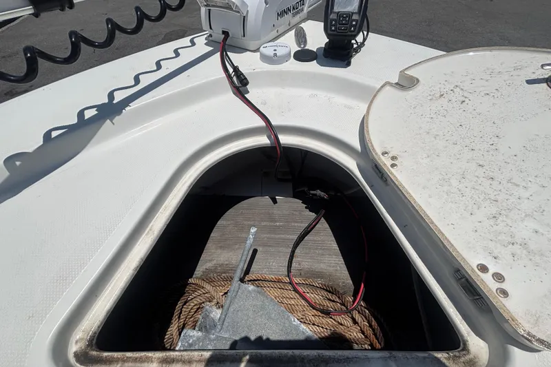 Slide: The Image of Open anchor storage on 2014 Mako 21 LTS boat with rope and wiring. - 33