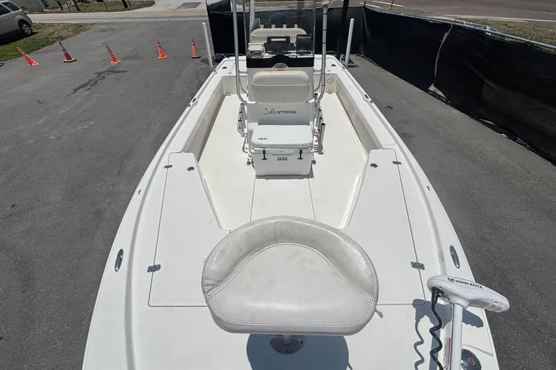 Slide: The Image of 2014 Mako 21 LTS boat with seating and fishing equipment on deck. - 36
