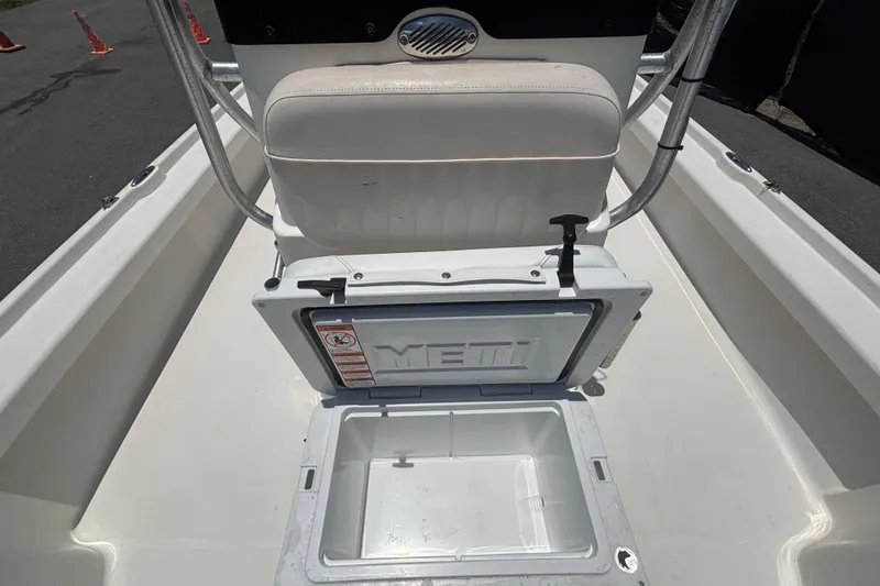 Slide: The Image of Open YETI cooler on 2014 Mako 21 LTS boat deck, showcasing storage space. - 38