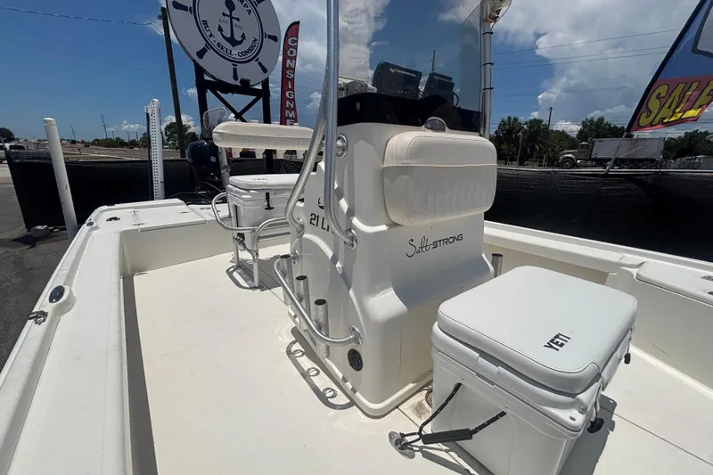 Slide: The Image of 2014 Mako 21 LTS boat interior with seating and Yeti cooler on deck. - 39