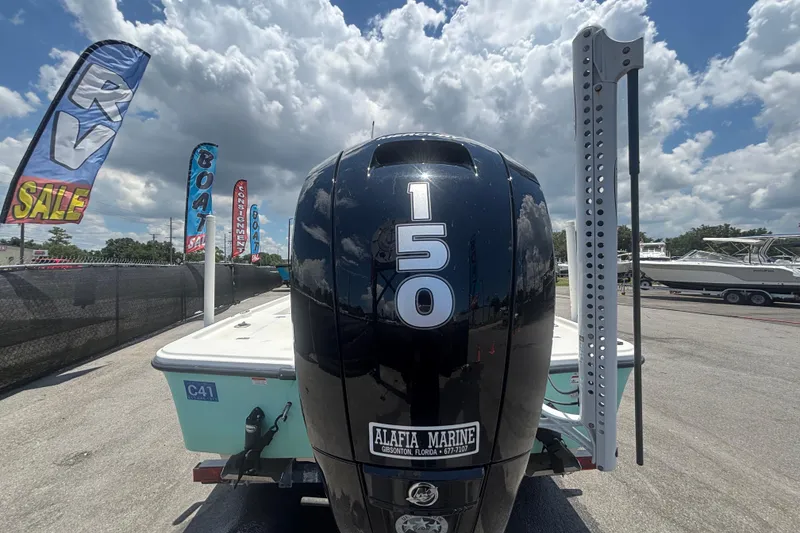 Slide: The Image of 2014 Mako 21 LTS boat with 150 HP engine at a sale event. - 4