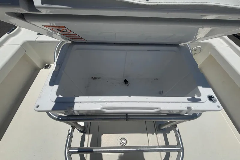 Slide: The Image of Open storage compartment on a 2014 Mako 21 LTS boat, showing interior space. - 42