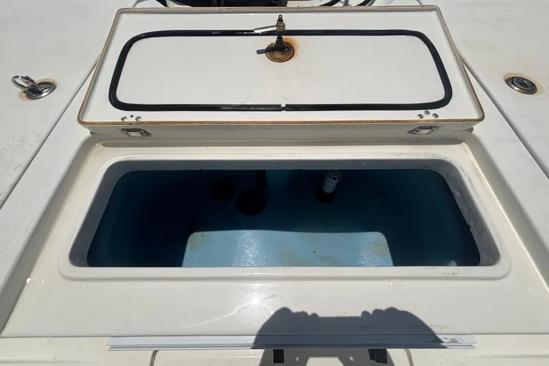 Slide: The Image of Open storage compartment on a 2014 Mako 21 LTS boat deck. - 45