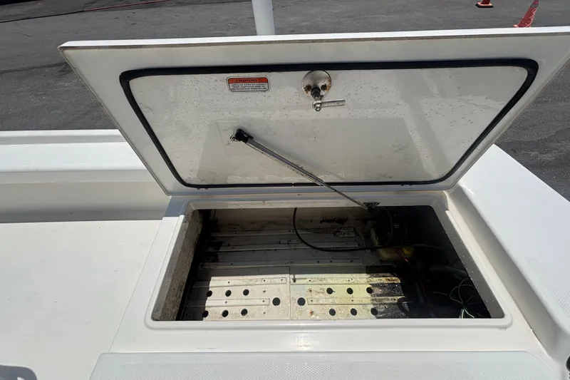Slide: The Image of Open storage compartment on a 2014 Mako 21 LTS boat, showing interior details. - 46