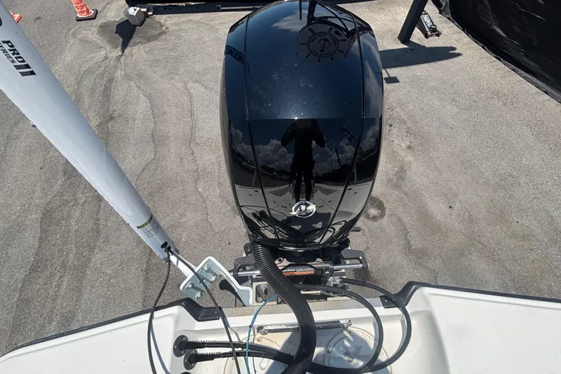 Slide: The Image of Overhead view of a 2014 Mako 21 LTS boat engine on pavement. - 48