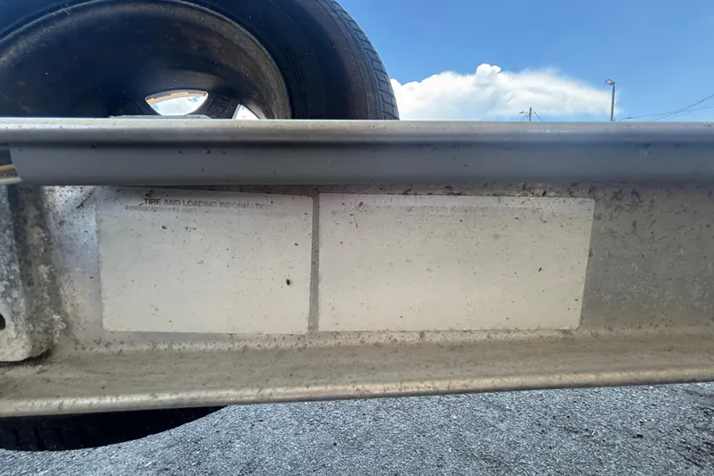 Slide: The Image of Trailer tire and loading information on a 2014 Mako 21 LTS boat trailer. - 50