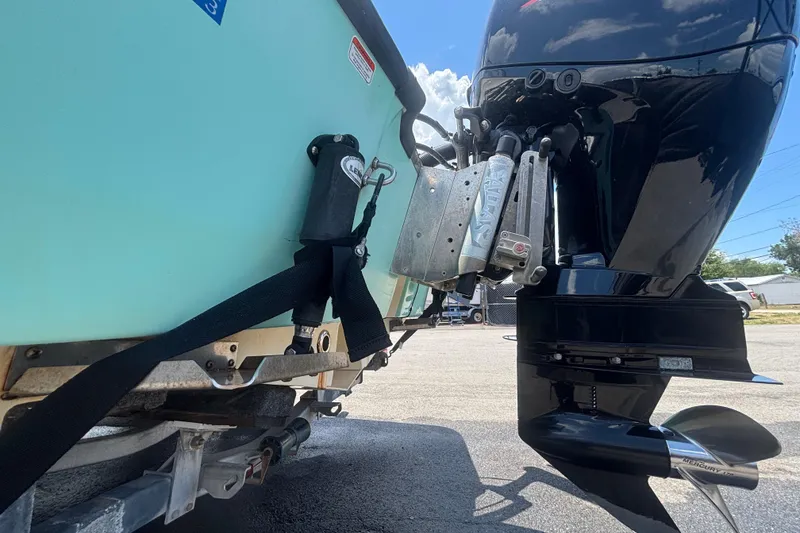 Slide: The Image of 2014 Mako 21 LTS boat with outboard motor and trailer, close-up view. - 6