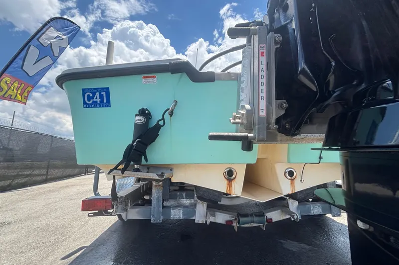 Slide: The Image of Rear view of a 2014 Mako 21 LTS boat on a trailer, with RV sale banner. - 7