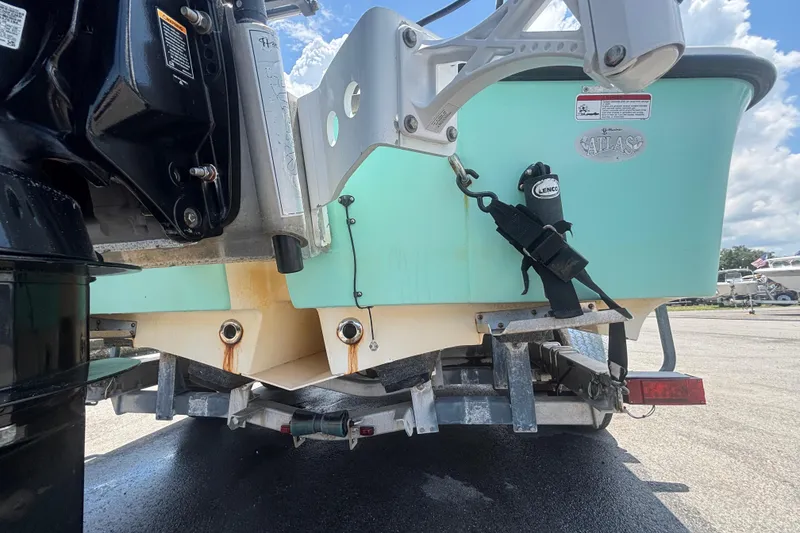 Slide: The Image of Rear view of a 2014 Mako 21 LTS boat on a trailer, showing motor and hull details. - 8