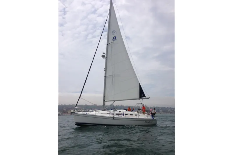 Slide: The Image of 2009 Hunter 38 sailboat on open water under cloudy sky. - 1