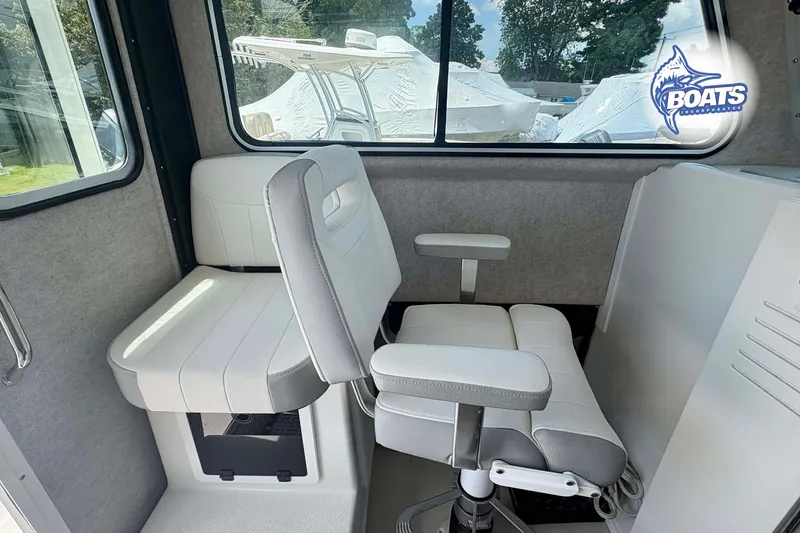 Slide: The Image of Interior of 2021 Parker 2520 XLD Sport Cabin with white seating and window view. - 10