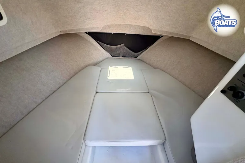 Slide: The Image of 2021 Parker 2520 XLD Sport Cabin interior with cushioned seating and storage. - 11