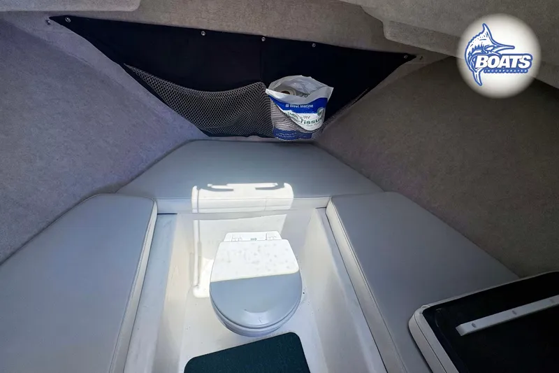 Slide: The Image of 2021 Parker 2520 XLD Sport Cabin interior with compact marine toilet and storage. - 12