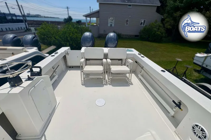 Slide: The Image of 2021 Parker 2520 XLD Sport Cabin boat deck with seating and dual engines. - 14