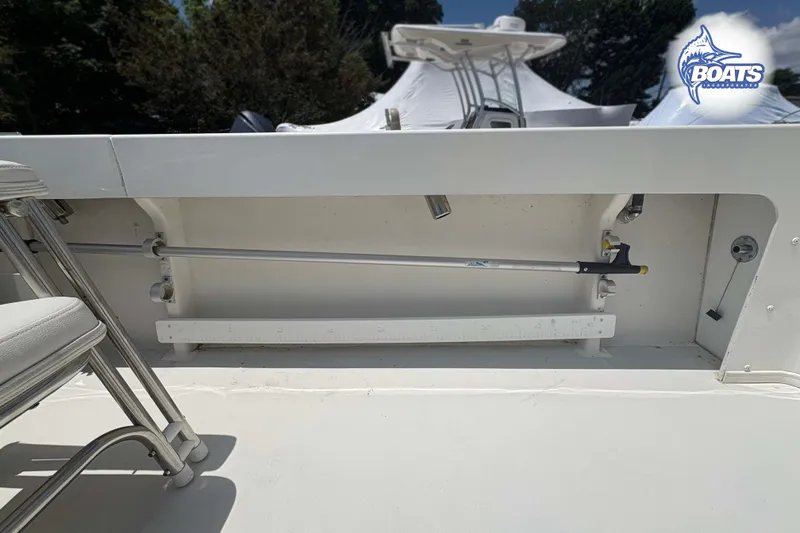 Slide: The Image of 2021 Parker 2520 XLD Sport Cabin boat interior with rod holder and seating. - 15