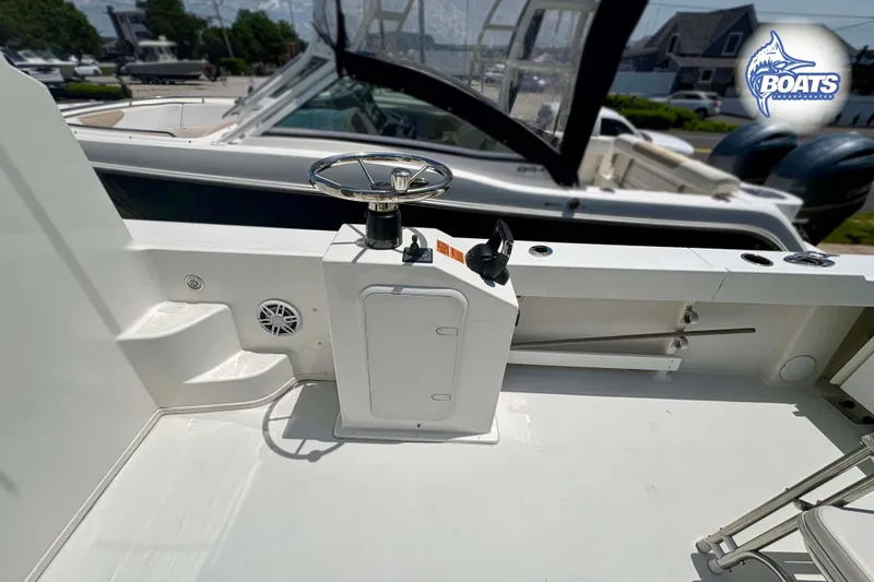 Slide: The Image of 2021 Parker 2520 XLD Sport Cabin boat deck with steering wheel and control panel. - 16