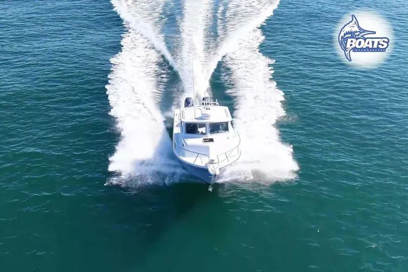 Slide: The Image of 2021 Parker 2520 XLD Sport Cabin cruising on open water, aerial view. - 2