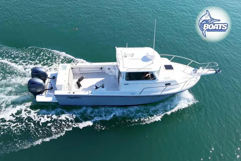 Slide: The Image of 2021 Parker 2520 XLD Sport Cabin boat cruising on clear blue water. - 3