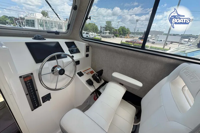 Slide: The Image of Interior of 2021 Parker 2520 XLD Sport Cabin with steering wheel and dashboard controls. - 7