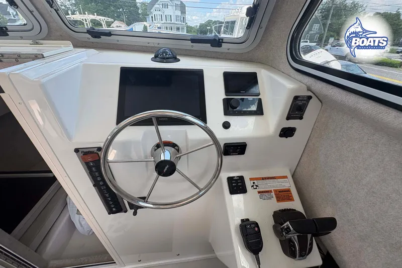 Slide: The Image of Helm of 2021 Parker 2520 XLD Sport Cabin with steering wheel and controls. - 8
