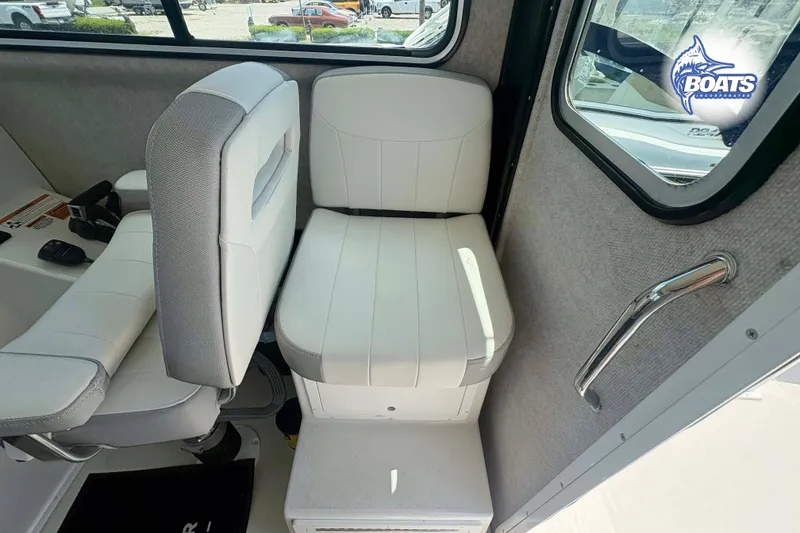 Slide: The Image of Interior of 2021 Parker 2520 XLD Sport Cabin with white seating and window view. - 9