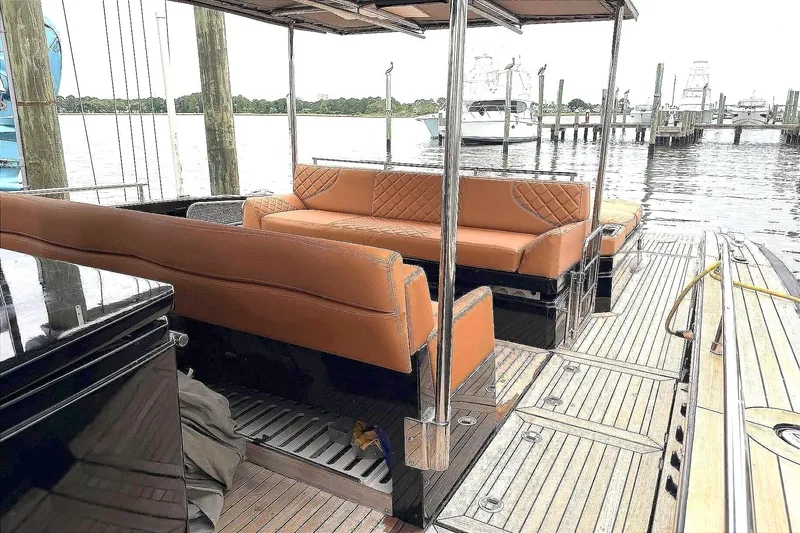 Slide: The Image of Luxurious 2013 Windy SR52 yacht interior with tan leather seating and wooden deck. - 11