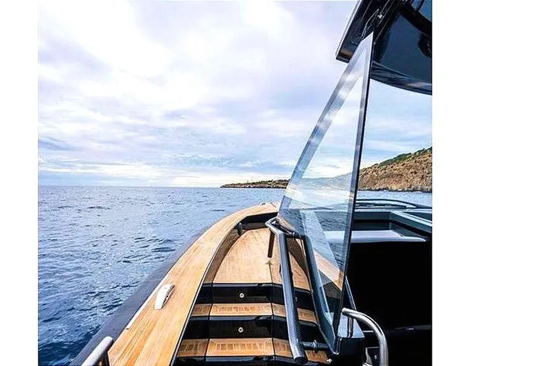 Slide: The Image of Windy SR52 yacht cruising on open sea, showcasing sleek design and wooden deck, 2013 model. - 12