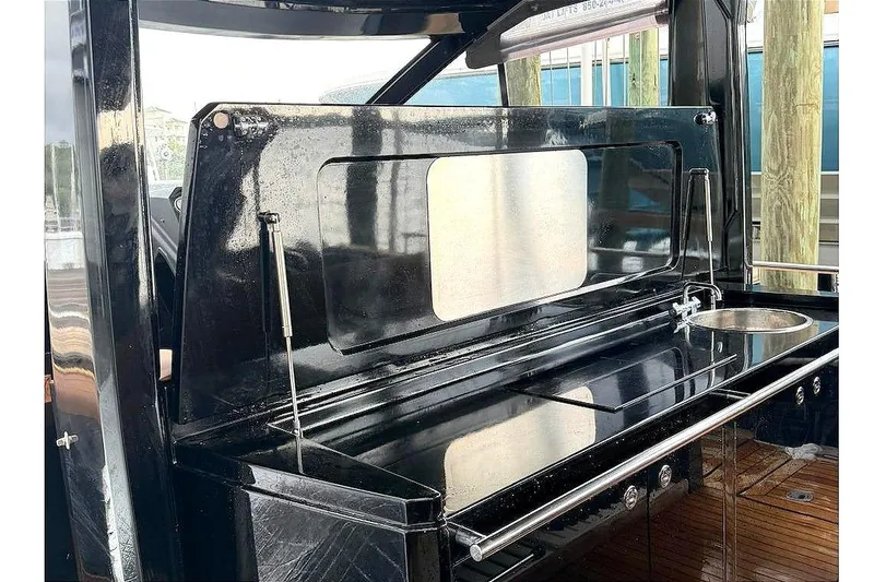 Slide: The Image of Outdoor kitchen area on a 2013 Windy SR52 yacht, featuring sleek black cabinetry. - 17