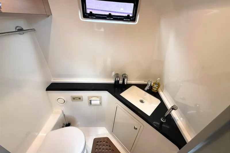 Slide: The Image of Compact bathroom in 2013 Windy SR52 yacht with sink, toilet, and window. - 22