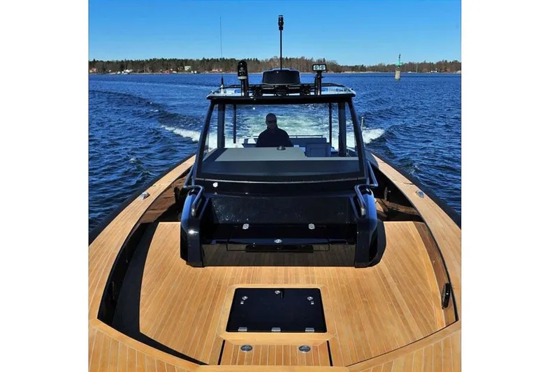 Slide: The Image of 2013 Windy SR52 yacht with sleek wooden deck cruising on open water. - 24