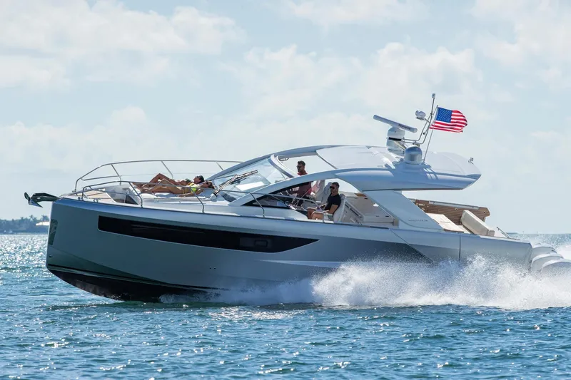 The Image of 2027 Jeanneau DB/43 OB yacht cruising on open water with passengers enjoying the ride. - 0