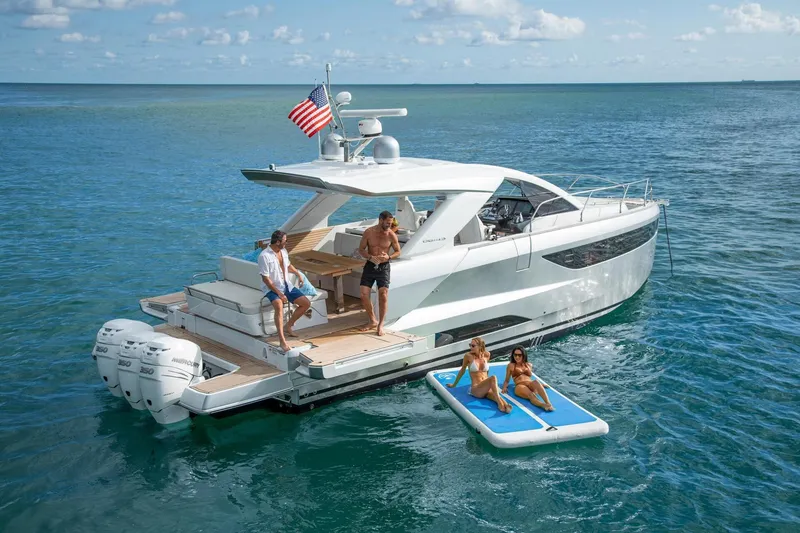 Slide: The Image of 2027 Jeanneau DB/43 OB yacht with people relaxing on deck and floating mat. - 17