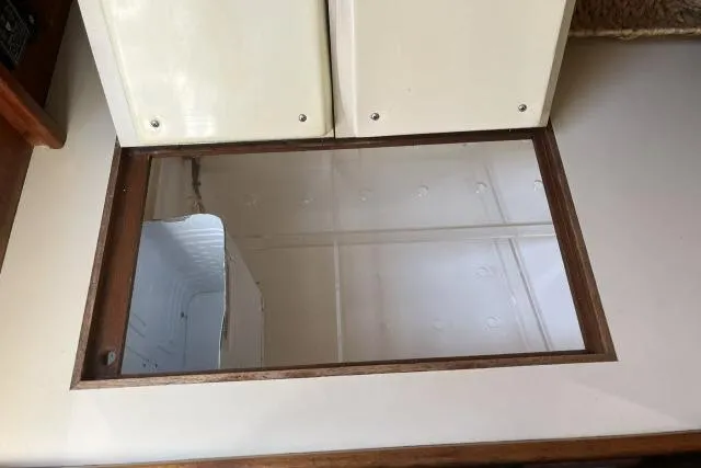 Slide: The Image of Interior view of 1985 Islander Peterson 40 sailboat, featuring a reflective surface and cabinetry. - 10