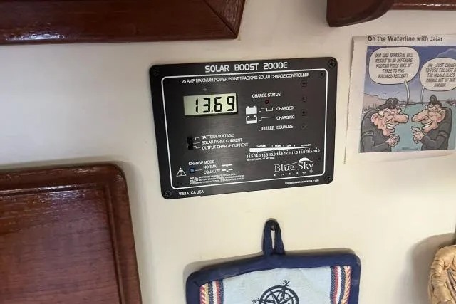 Slide: The Image of Solar Boost 2000E charge controller on 1985 Islander Peterson 40 yacht, displaying voltage reading. - 13