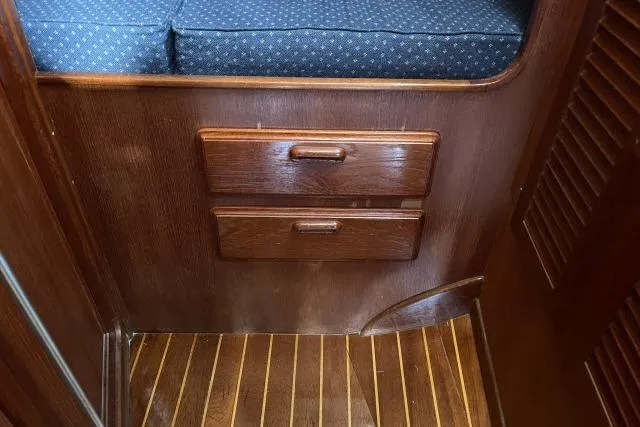 Slide: The Image of Interior of 1985 Islander Peterson 40 yacht with wooden drawers and cushioned seating. - 15