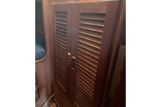 Slide: The Image of Wooden louvered cabinet doors inside 1985 Islander Peterson 40 sailboat interior. - 18