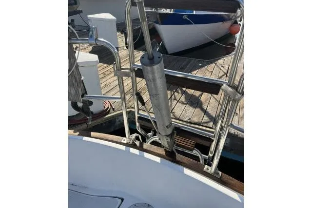 Slide: The Image of 1985 Islander Peterson 40 sailboat deck with stainless steel fittings and wooden accents. - 24