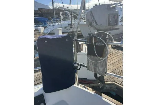 Slide: The Image of 1985 Islander Peterson 40 sailboat with outboard motor at marina dock. - 26