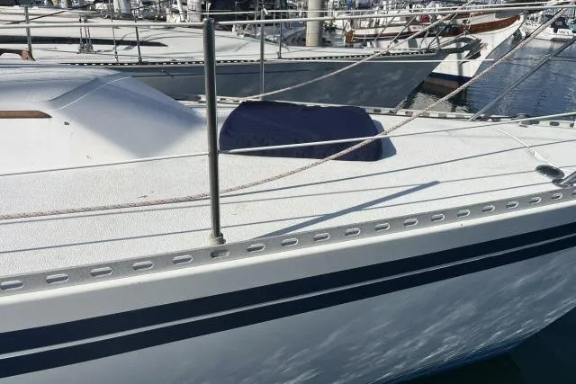 Slide: The Image of 1985 Islander Peterson 40 sailboat deck with railing, docked in a marina. - 32