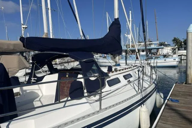 Slide: The Image of 1985 Islander Peterson 40 sailboat docked at marina under clear blue sky. - 34
