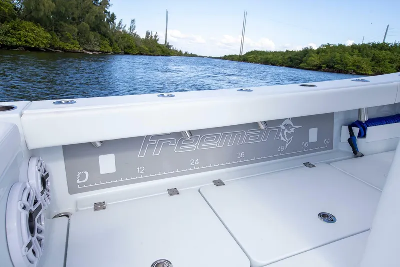 Slide: The Image of Freeman 28 boat 2023 on calm water with green shoreline. - 17