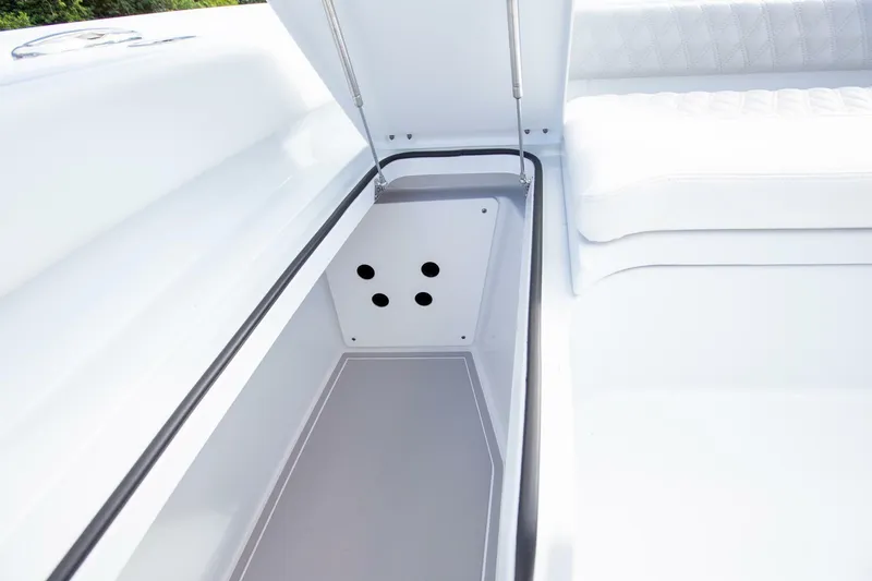 Slide: The Image of Freeman 28 boat 2023, open storage compartment with cushioned seating. - 22