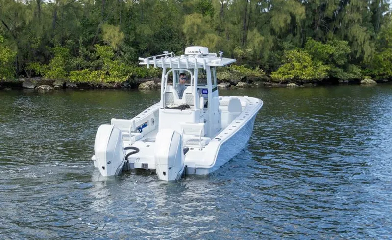 Slide: The Image of Freeman 28 boat 2023 on calm water near green shoreline. - 5