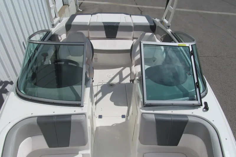 Slide: The Image of 2019 Chaparral 21 H2O Sport boat interior with open windshield and seating. - 11