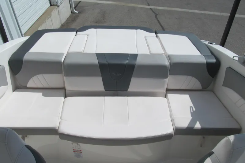 Slide: The Image of 2019 Chaparral 21 H2O Sport boat interior with white and gray seating. - 12
